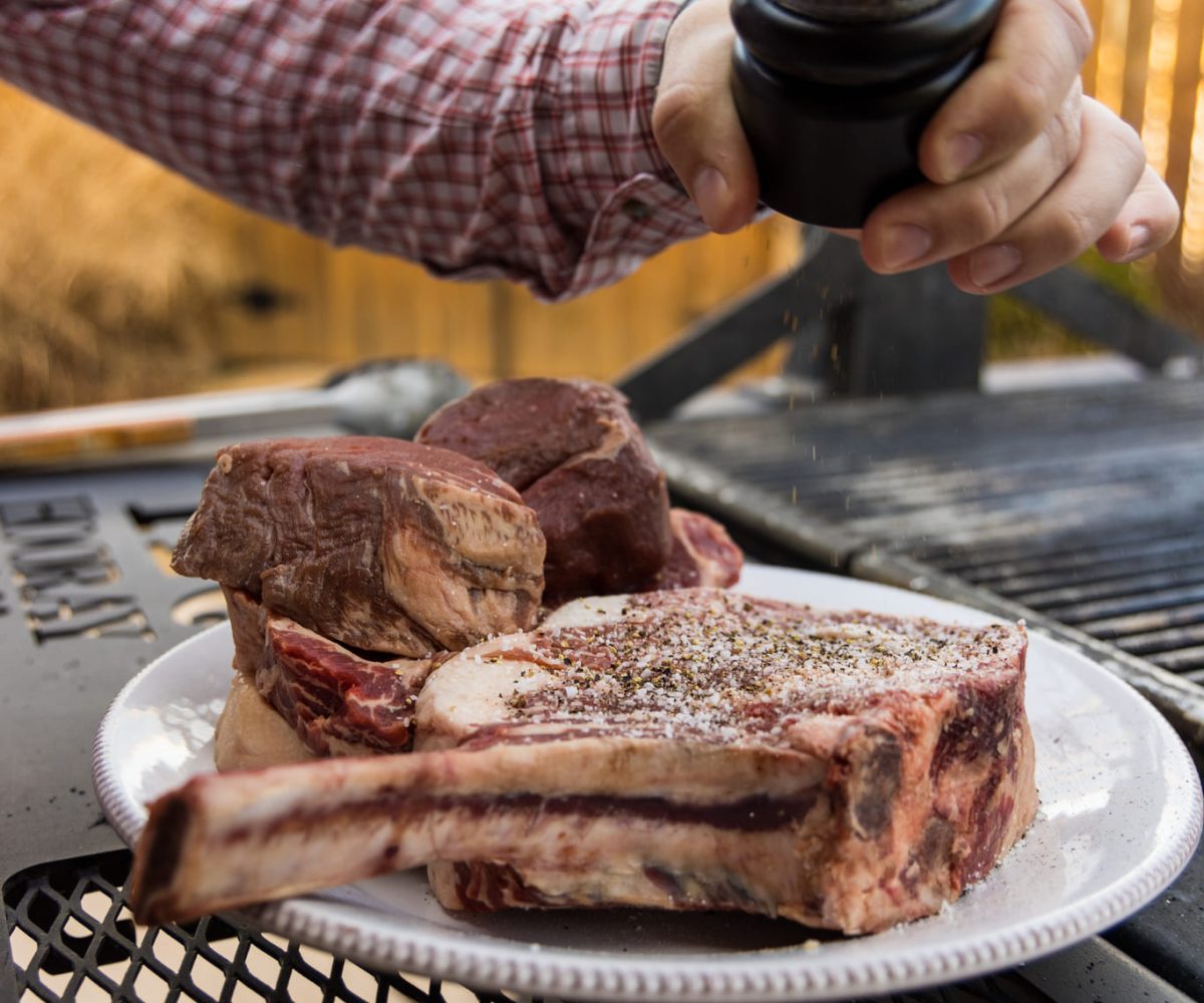 Meat being seasoned